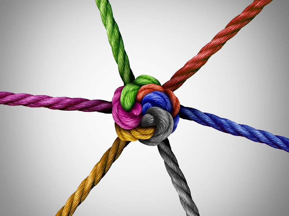 United together symbol and diversity connection as a group of ropes tied at a central point as a business metaphor for corporate or community cooperation success.